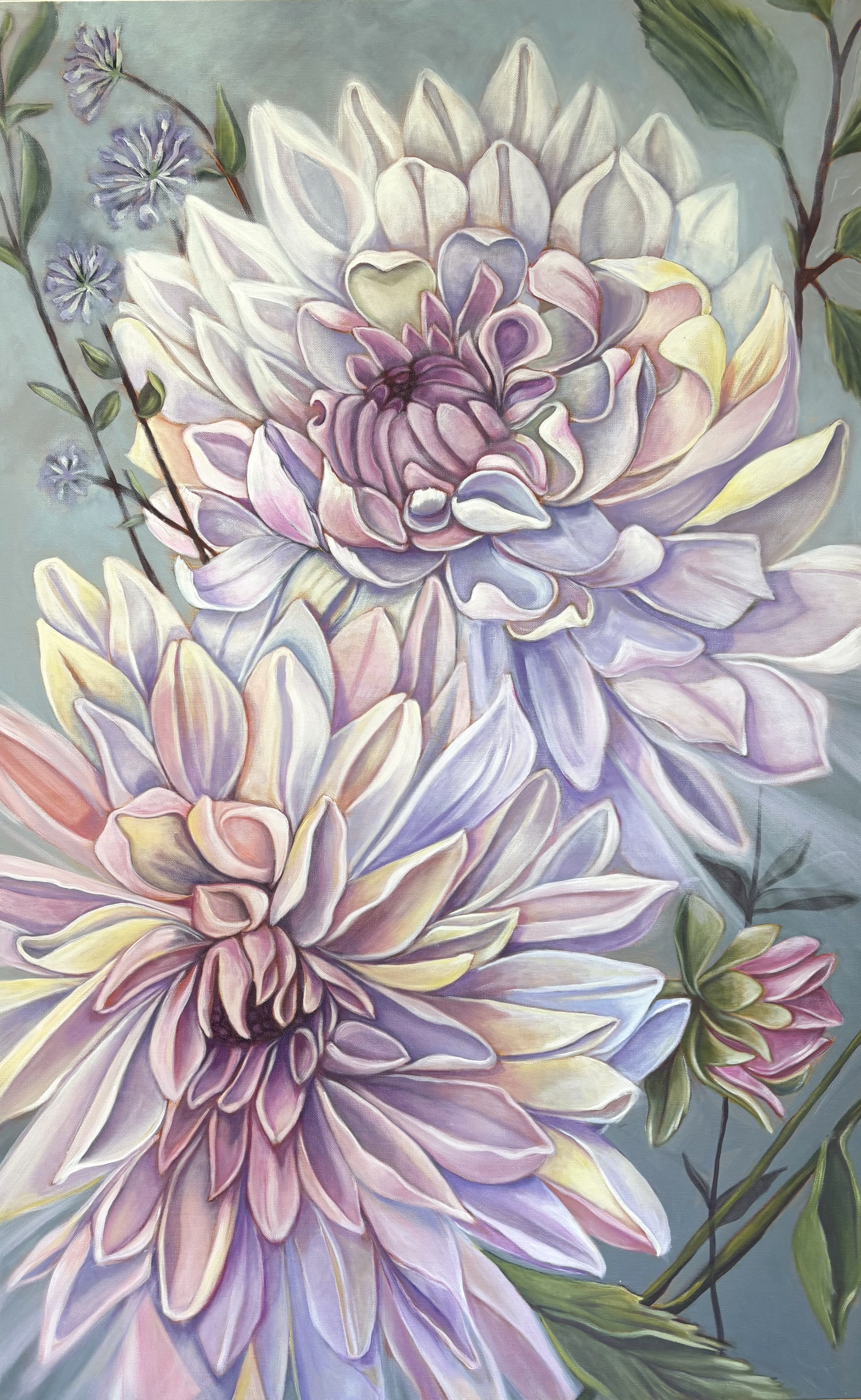 The Duet — 30 x 48 — is a celebration of partnership in full bloom. Two luminous dahlias rise together in a vertical harmony, their layered petals rendered in soft washes of blush, lilac, pale butter yellow, and pearl white against a quiet, misty blue-gray ground. The upper bloom opens with cool, airy grace while the lower answers in warmer pinks, creating a gentle call-and-response that gives the painting its title. Delicate scabiosa sprigs and fresh green foliage frame the pair, and a small, half-open bud at the edge hints at what's still to come. Painted with loose, expressive realism and an emphasis on light, the piece feels both grand in scale and intimate in mood — a duet of color, form, and companionship.